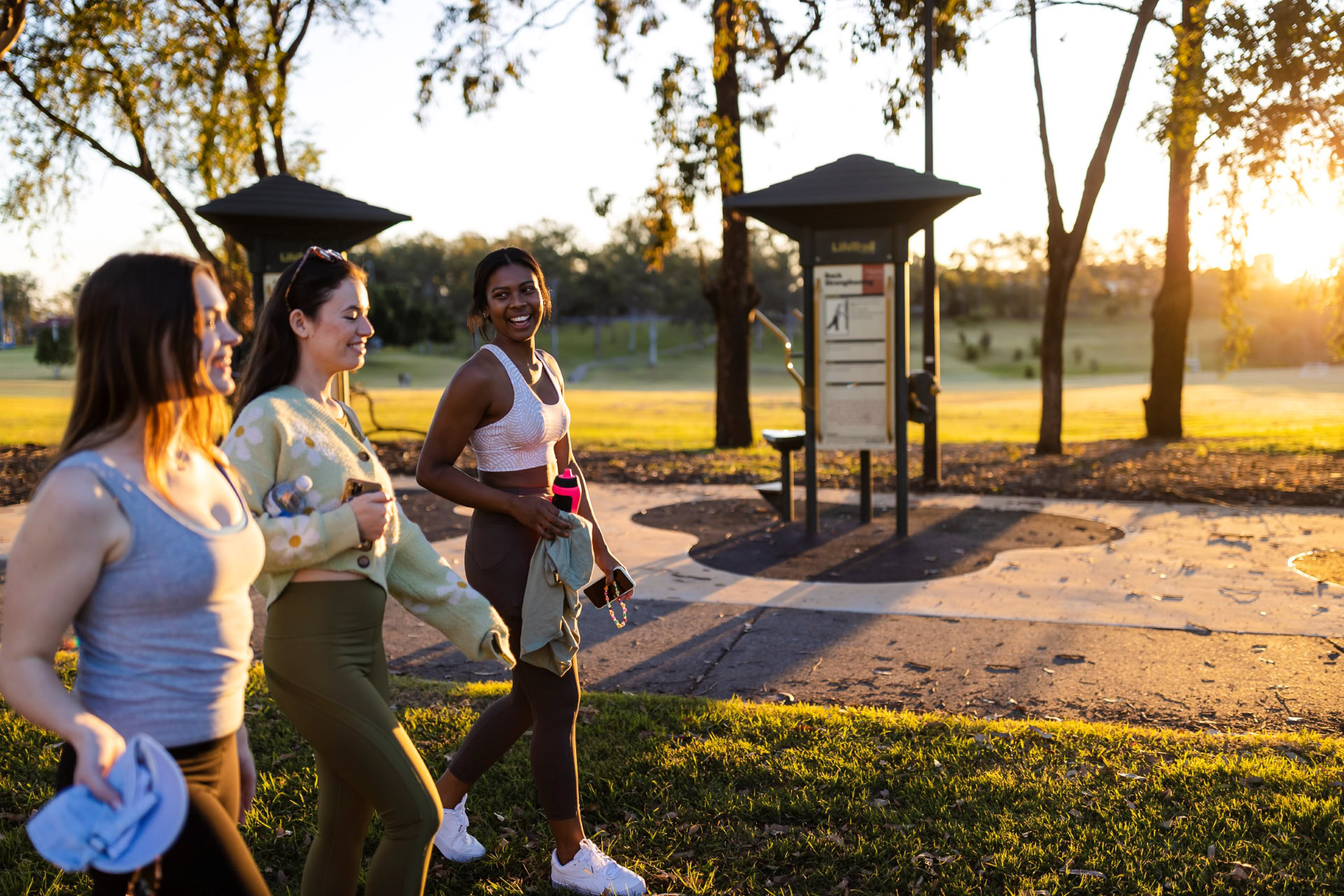 Three women walking in park in activewear
