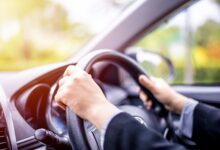 Woman driving car on a sunny morning