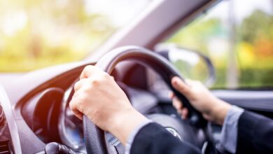 Woman driving car on a sunny morning