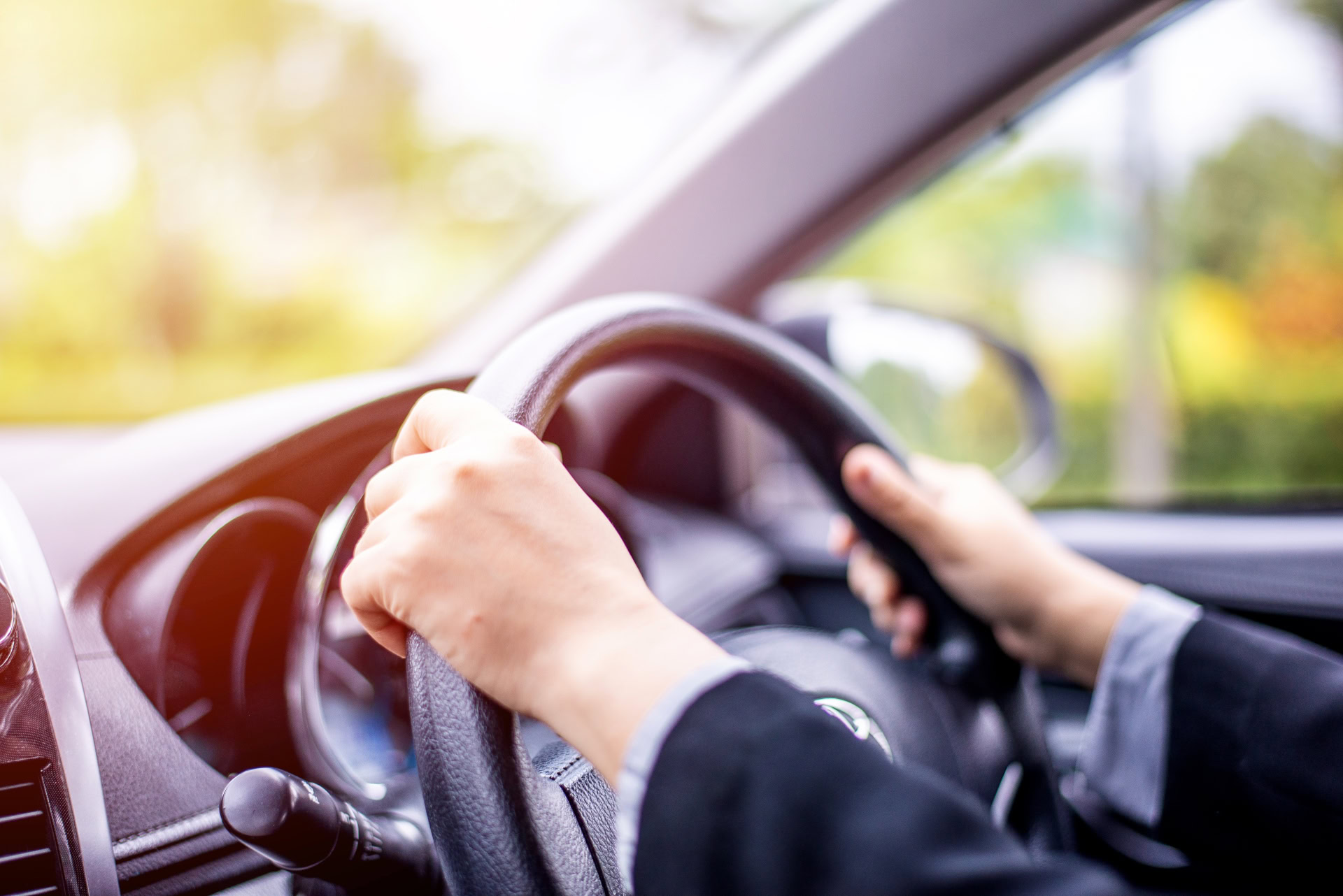 Woman driving car on a sunny morning